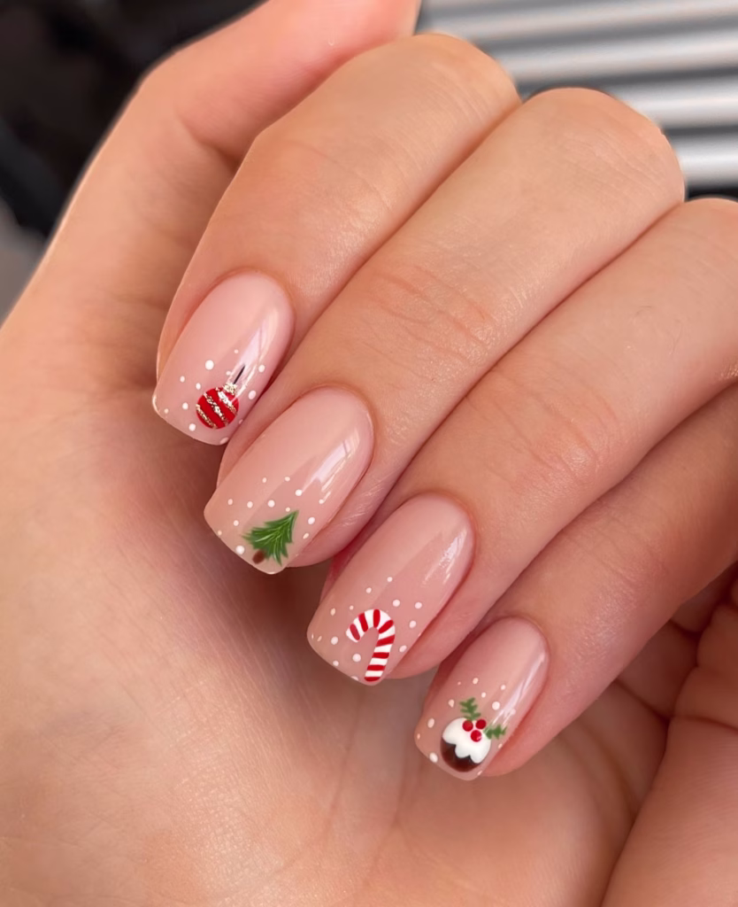 Nude Christmas nails with mini festive icons and candy canes.